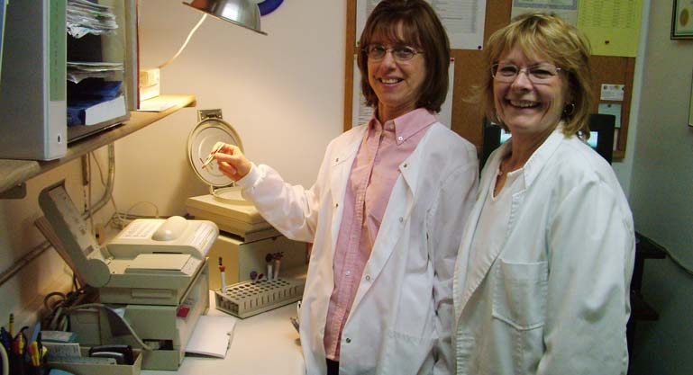 Mary Tadic and Cherie Mielke demonstrate the new QBC blood machine